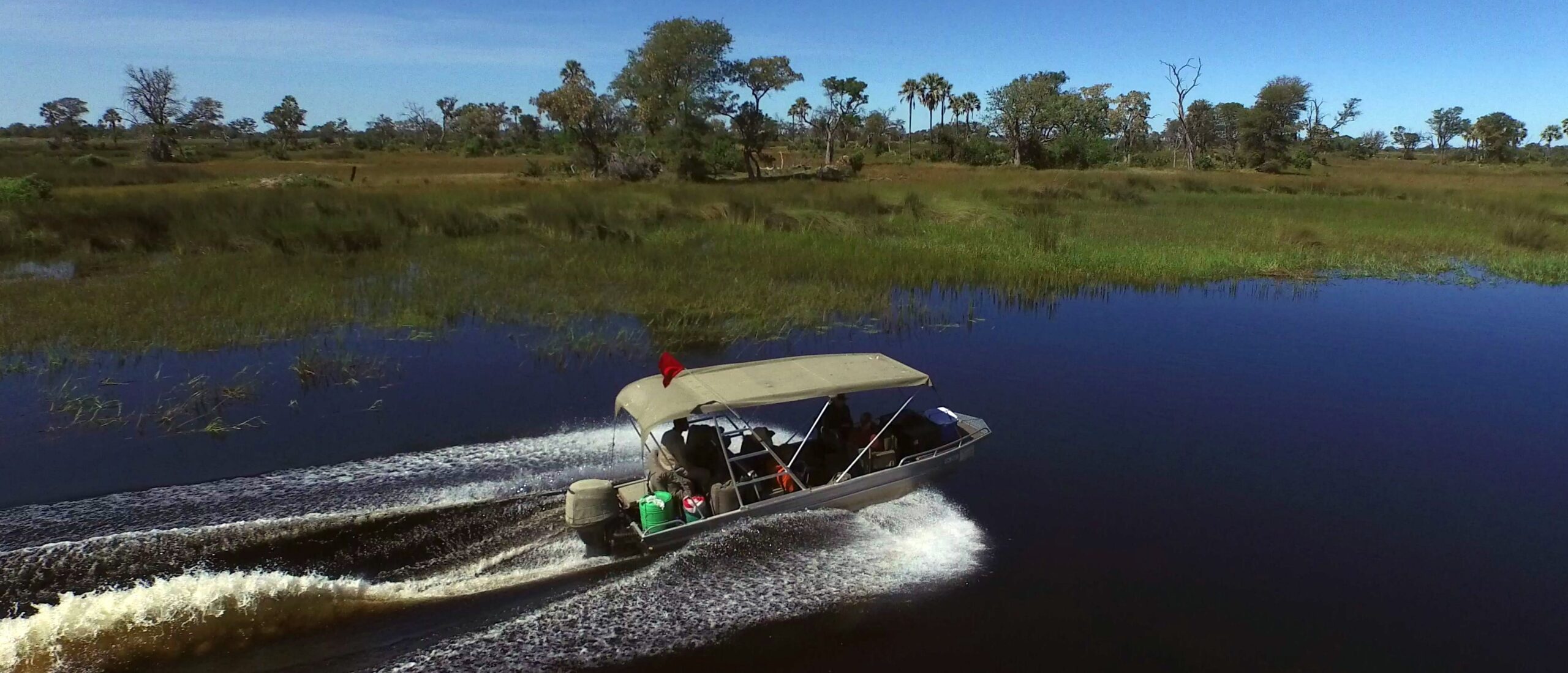 Aerial photo of a motorboat near Chiefs island Okavango delta.